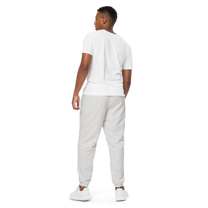 Back view of a man wearing unisex Platinum track pants and a white t-shirt, showcasing a lightweight, comfortable design.