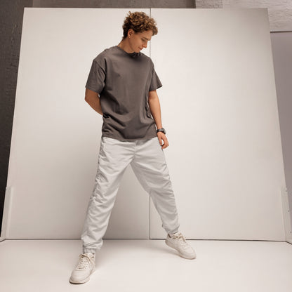 Unisex track pants Platinum in gray, styled with a matching tee and sneakers for a trendy streetwear look.