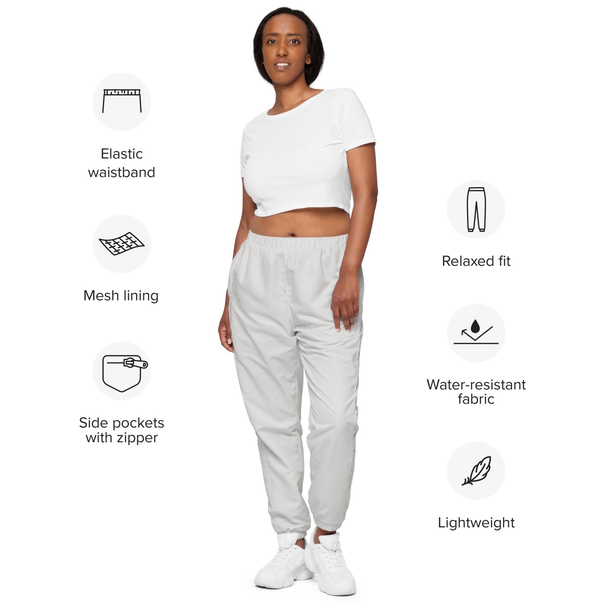 Unisex track pants featuring elastic waistband, mesh lining, relaxed fit, water-resistant fabric, and lightweight design.