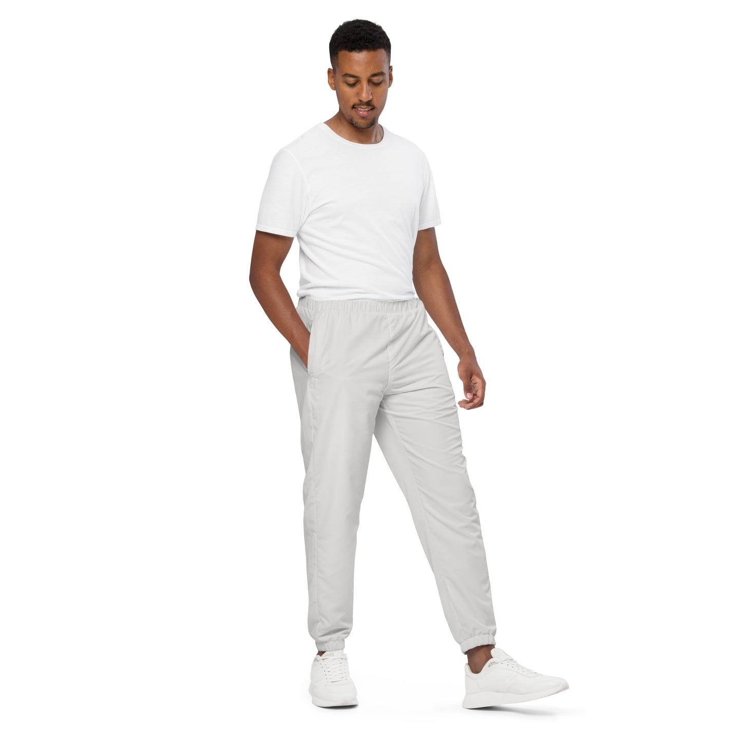 Unisex track pants in platinum color, featuring elastic cuffs and lightweight, water-resistant fabric for comfort.